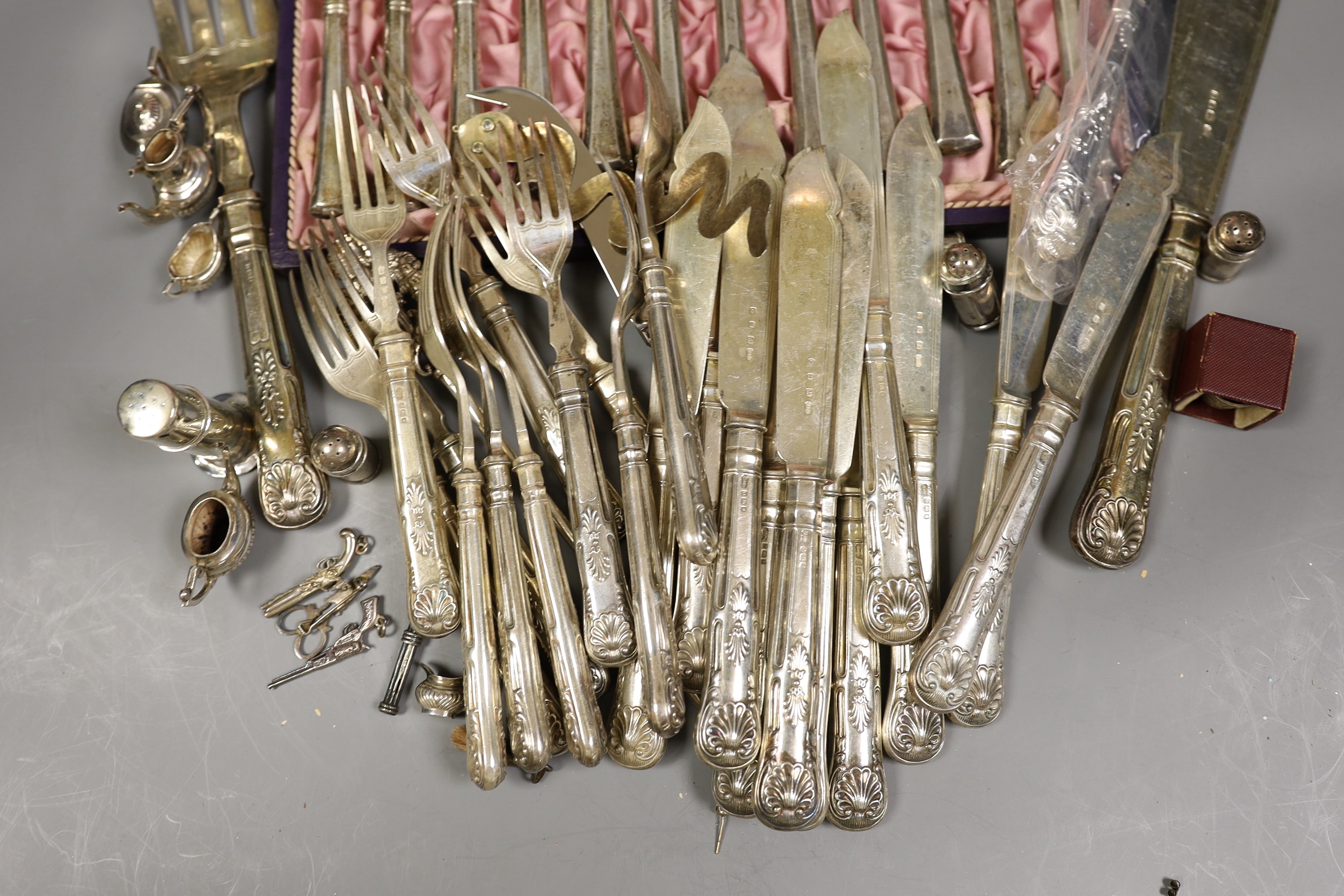 A pair of George VI silver fish servers, Carrington & Co, London 1939 and eleven pairs of matching fish eaters, together with a continental white metal skewer, a modern silver handled cake slice and cheese knife, a lady'